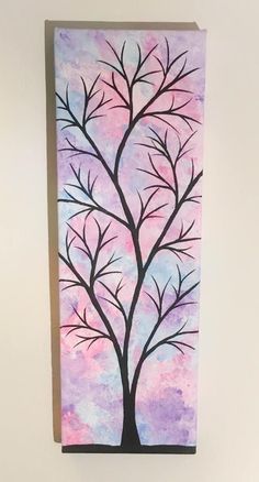 a painting of a tree with pink and purple colors on it, hanging on a wall