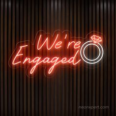 we're engaged neon sign on the wall