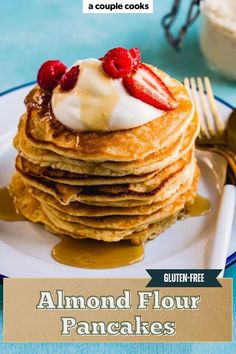 a stack of pancakes with whipped cream and strawberries on top, sitting on a plate