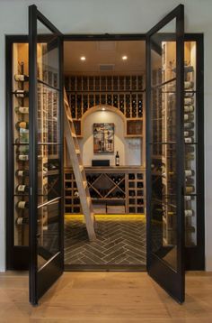 an open wine cellar with stairs leading up to it