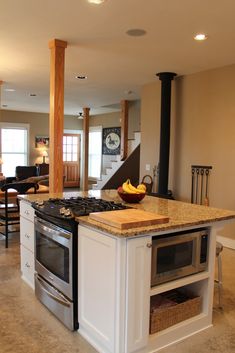 a kitchen with an island and stove in it