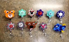 a group of different colored key chains on a counter with eyes and ears attached to them