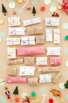 presents are laid out on a table with confetti and christmas decorations around them