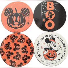 four halloween coasters with mickey mouse and pumpkin faces on them, all decorated in black and orange