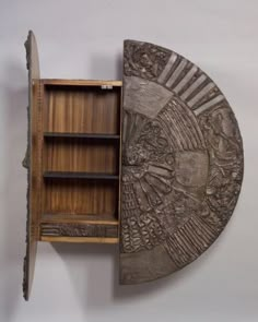 a wooden shelf with an intricate carving on it