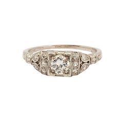 an antique diamond ring with three stone accents