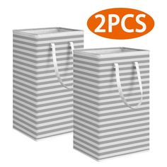 two gray and white striped shopping bags with orange 2 pc's on the top