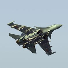 a fighter jet flying in the sky with its landing gear down