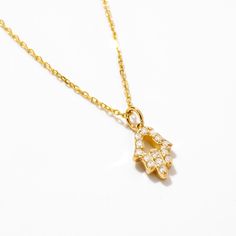 1- D E S C R I P T I O N Unveil your inner strength with our Diamond Hamsa Hand Necklace in 14K Solid Gold. An exquisite symbol of protection, this Evil Eye Necklace for women features a Hamsa Hand Pendant, making it an ideal gift for her. Handcrafted with love, this piece adds a touch of elegance to any outfit, promoting positive energy and warding off negativity. 2- P R O D U C T ∙  F E A T U R E S * Gold material: 14k solid gold * Gold color options: Yellow gold, Rose gold, White gold * Stone: Diamond Diamond Carat: 0.07 ct. Diamond Clarity: VS2 Diamond Color: F-G Diamond Cut: Excellent Diamond Setting: Pave setting * Choice of chain length: 14", 16", 18", 20" * Dimensions: Pendant Height: 7 mm / 0.27 in Pendant Width: 5 mm / 0.19 in 3- D E L I V E R Y ∙ D E T A I L S We understand that Symbolic Sterling Silver Necklace With Delicate Chain, Symbolic Jewelry With Delicate Chain Pendant, Symbolic Pendant Jewelry With Delicate Chain, Symbolic Pendant With Delicate Chain, Gift Yellow Gold Diamond Necklace Si Clarity, Symbolic White Gold Tarnish-resistant Necklace, Yellow Gold Diamond Necklace With Si Clarity As Gift, Yellow Gold Si Clarity Diamond Necklace Gift, Women Protection