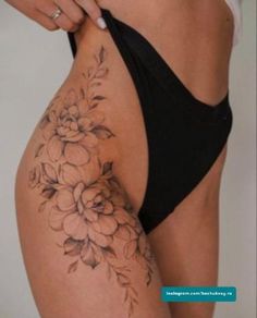 a woman's lower body with flowers on her stomach and the bottom half of her panties