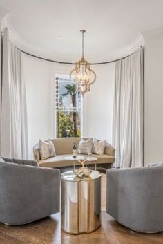 a living room filled with furniture and a chandelier