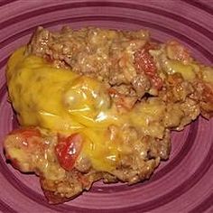 a purple plate topped with meat covered in cheese