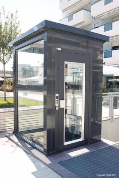 a public toilet sitting on top of a sidewalk