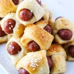 a pile of hot dogs wrapped in bread