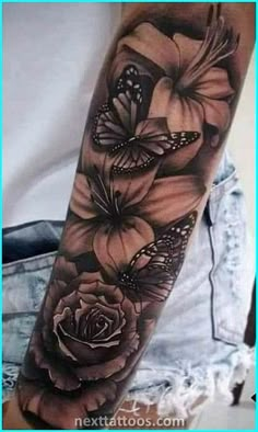 a woman's arm with flowers and butterflies on it