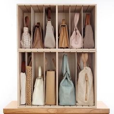 several purses are lined up in a wooden box