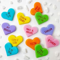 conversation hearts with names on them sitting on a white surface in the shape of hearts