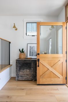 a wooden door sitting inside of a living room