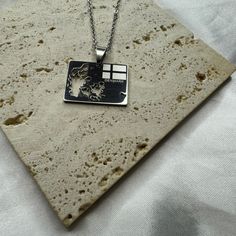 a square pendant with a horse on it