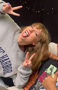 a girl making the peace sign with her fingers