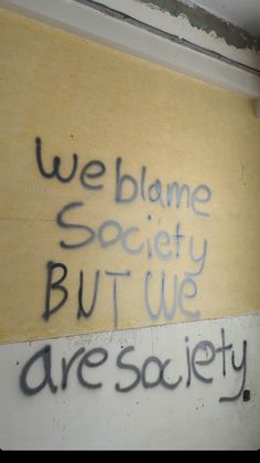 graffiti on the side of a building that says we blame society but we are sa