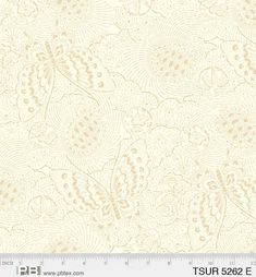 a white and gold wallpaper with an intricate design on the front, along with a ruler