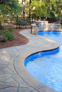 a large swimming pool surrounded by stone steps