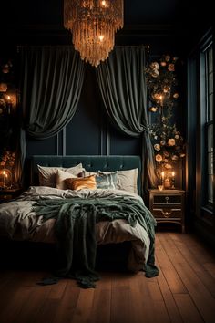 a large bed sitting under a chandelier in a bedroom next to a window