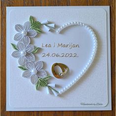 a heart shaped card with flowers and a wedding ring on it that says lea's marriage