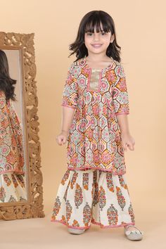 Combine tradition and fashion in this beautiful kurta set from Adiva - perfect for your little girl's next big event. Paired with flats and bangles. This ethnic suit consists of a block printed fit and flared Anarkali Kurti and a pair of sharara. The soft cotton fabric makes the dress most comfortable and stylish, sharara set has a flared bottom hem. Flared Anarkali, Kurta With Sharara, Kids Indian Wear, Kids Kurta, Kurta Sharara Set, Angrakha Style, Kurta Cotton, Ethnic Suit, Kurta Sharara