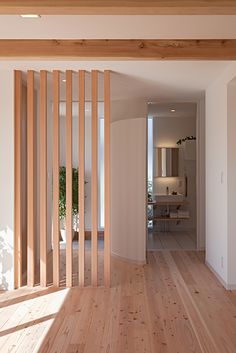 an empty room with wooden slats on the wall and wood floors in front of it