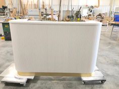 a large white radiator sitting on top of a dolly