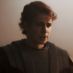 a young man with curly hair wearing a star wars costume and looking at the camera