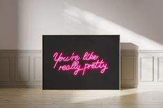 there is a neon sign that says you're like really pretty on the wall