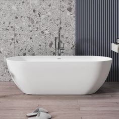 a white bath tub sitting on top of a wooden floor