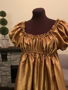 This dazzling gown is the perfect summer dress for any renaissance or regency era ensemble! The ultra-full gown features an empire waistline, hitting right below the bust. The fabric is a light-weight brilliant gold crushed taffeta, and will add that elegant touch to your existing wardrobe. Over 5 yards of fabric go into this dress. The neckline is elasticized and can be pulled low off the shoulders and the empire waistline is also elastic. The short sleeves measure 4 inches from underarm to ela Jane Austen Pride And Prejudice, Full Gown, Regency Dress, Regency Era, Taffeta Dress, Empire Waistline, Under Dress, Fantasy Dress, Pride And Prejudice