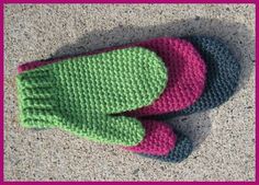 a pair of crocheted slippers sitting on top of a cement floor next to a pink frame