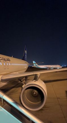 an airplane sitting on the tarmac at night with its landing gear down and it's engine out