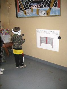 a young boy standing in front of a white board