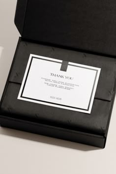 a black box with a white label on it that says thank you and is open