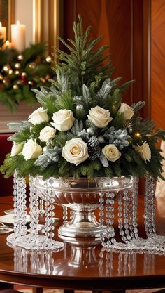 a christmas centerpiece with white roses and greenery