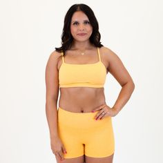 Our Bandeau Sports Bra features straight straps and sleek support for freedom of movement, in style. Heather Marigold is a warm and sunny yellow-orange hue, reminiscent of a vibrant marigold flower in full bloom. This color exudes positivity and energy, making it perfect for those who want a soft burst of color. 1" elastic band A-B cup: medium support, high coverage C-DD cup: low support, medium coverage Straight straps Wide, straight neckline Removable bra cups included Sarah is a 34B wearing s Yellow Stretch Sports Bra For Yoga, Yellow Sleeveless Stretch Sports Bra, Yellow Stretch Sports Bra, Yellow Stretch Sports Bra, Casual Style, Yellow Seamless Stretch Sports Bra, Muscle Tanks, Freedom Of Movement, Bra Cups, Leggings Shop