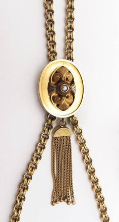 Presented is a beautifully hand crafted, Victorian 14 karat yellow gold chain necklace. This antique piece was made during the mid to late 1800s. The chain is done in a double loop or link form. The whole chain is completely hand made. The chain has a very decorative slider on it. The slider is set in the center with a natural pearl and there is a tassel dangling at the bottom. The tassel is in fabulous condition, which is very surprising for a piece of this age. This piece has been tested with Antique Oval Link Gold Chain Jewelry, Victorian Gold Chain Necklace With Oval Links, Elegant Gold-tone Chain Necklace With Locket, Elegant Antique Gold Chain Jewelry, Antique Style Oval Link Chain Necklace, Victorian Jewelry With Oval Link Gold Chain, Victorian Oval Link Gold Chain Jewelry, Victorian Gold Chain Jewelry With Oval Links, Victorian Gold Chain Necklace For Formal Occasions