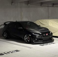 two cars parked next to each other in a parking garage