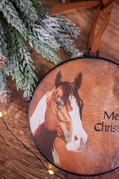 a christmas ornament with a brown and white horse's face on it