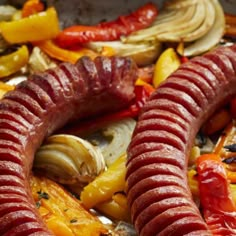 sausages, peppers, and other vegetables are arranged on a platter