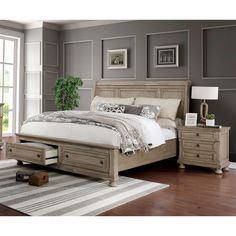 a bed sitting in a bedroom next to a dresser with drawers on top of it