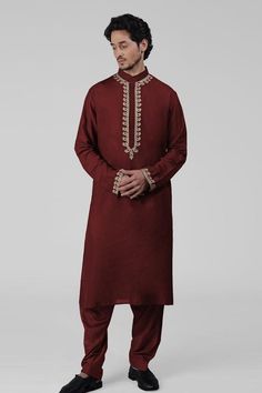 Maroon kurta featuring intricate tilla embroidery and delicate gold thread work on the front placket, sleeves, and neckline. Paired with a pathani salwar.
Components: 2
Pattern: Embroidered
Type Of Work: Tilla
Neckline: Band collar
Sleeve Type: Long
Fabric: Silk
Color: Maroon
Other Details: 
Attached lining
Length:
Kurta: 47 inches
Sleeve: 27 inches
Placket: 15.5 inches
Salwar: 42 inches
Occasion: Mehendi and Puja - Aza Fashions