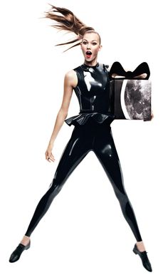 a woman in latex holding a present box with her hair flying through the air