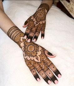 a woman's hands with hennap on top of white furnishing